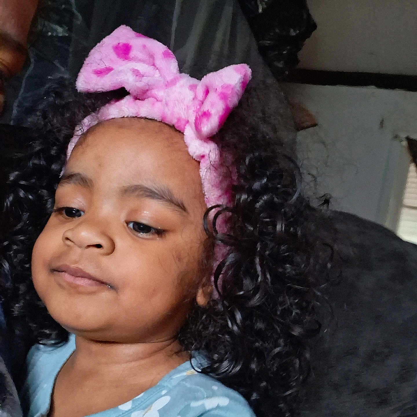 Eun-Ji joined the competition — help win amazing prizes! blue_shirt, child, clothing, couch, cozy, curly_hair, cute, expression, face, floral_pattern, hair_accessory, headband, home, indoor, person, pink, portrait, soft_lighting, toddler, young_child