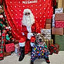 Diesel is registered to the contest to win money with this photo: dog, person, santa_claus, christmas, holiday, gift, present, sweater, decorations, tree, festive, smiling, indoor, costume, boots, glasses, floor, red_background, pet_smart, celebration