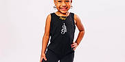 Alaiya is registered to the contest to win money with this photo: child, smile, posing, black_outfit, earrings, necklace, shorts, socks, standing, white_background, happy, fashion, portrait, studio, cute, person, confident, accessories, young, feet