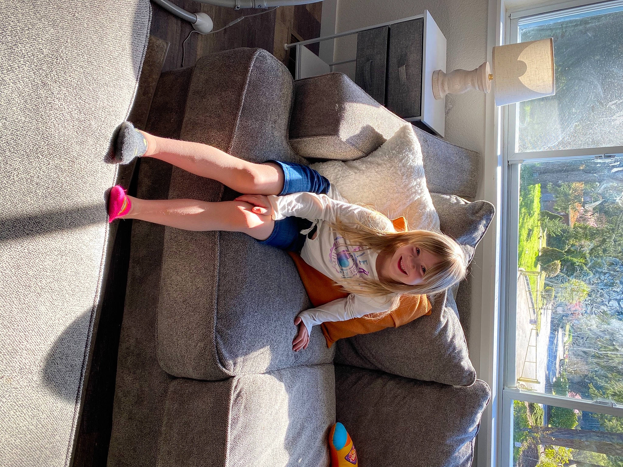 Caylee is registered to the contest to win money with this photo: art, building, comfort, couch, fun, human_leg, joy, leisure, person, plant, room, sitting, smile, street_fashion, thigh, travel, tree, vacation, window, wrist
