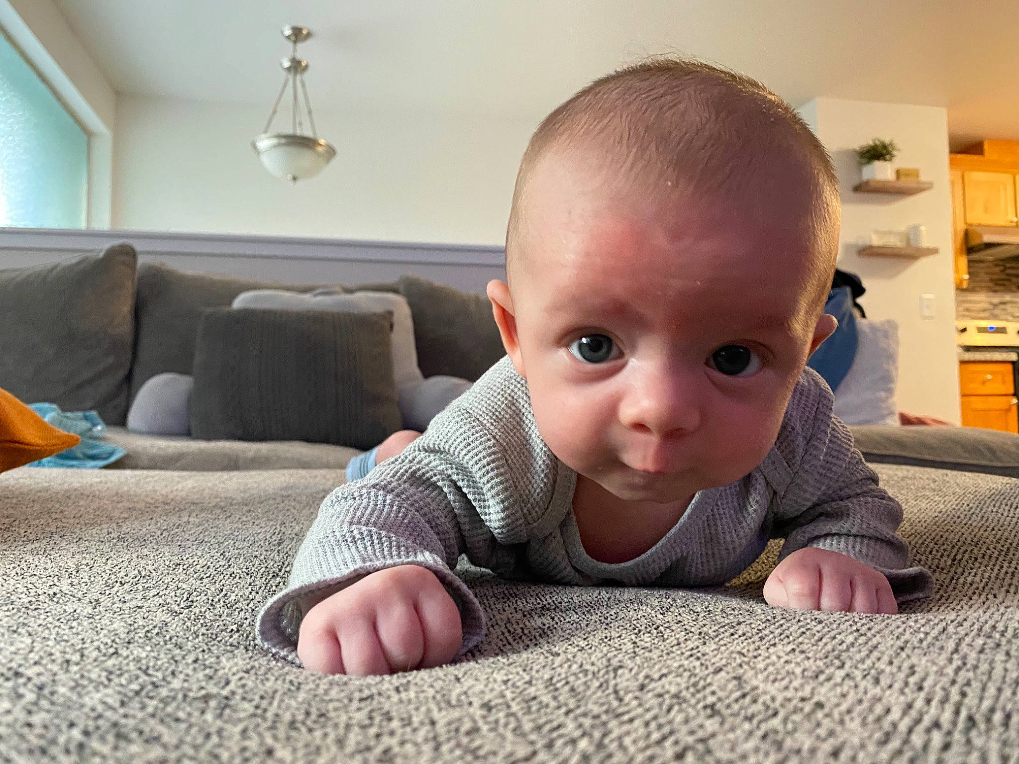 Karson joined the competition — help win amazing prizes! baby, baby_toddler_clothing, carpet, cheek, comfort, crawling, floor, flooring, grass, grey, hardwood, iris, nose, person, road_surface, shelf, sitting, toddler, tummy_time, wood