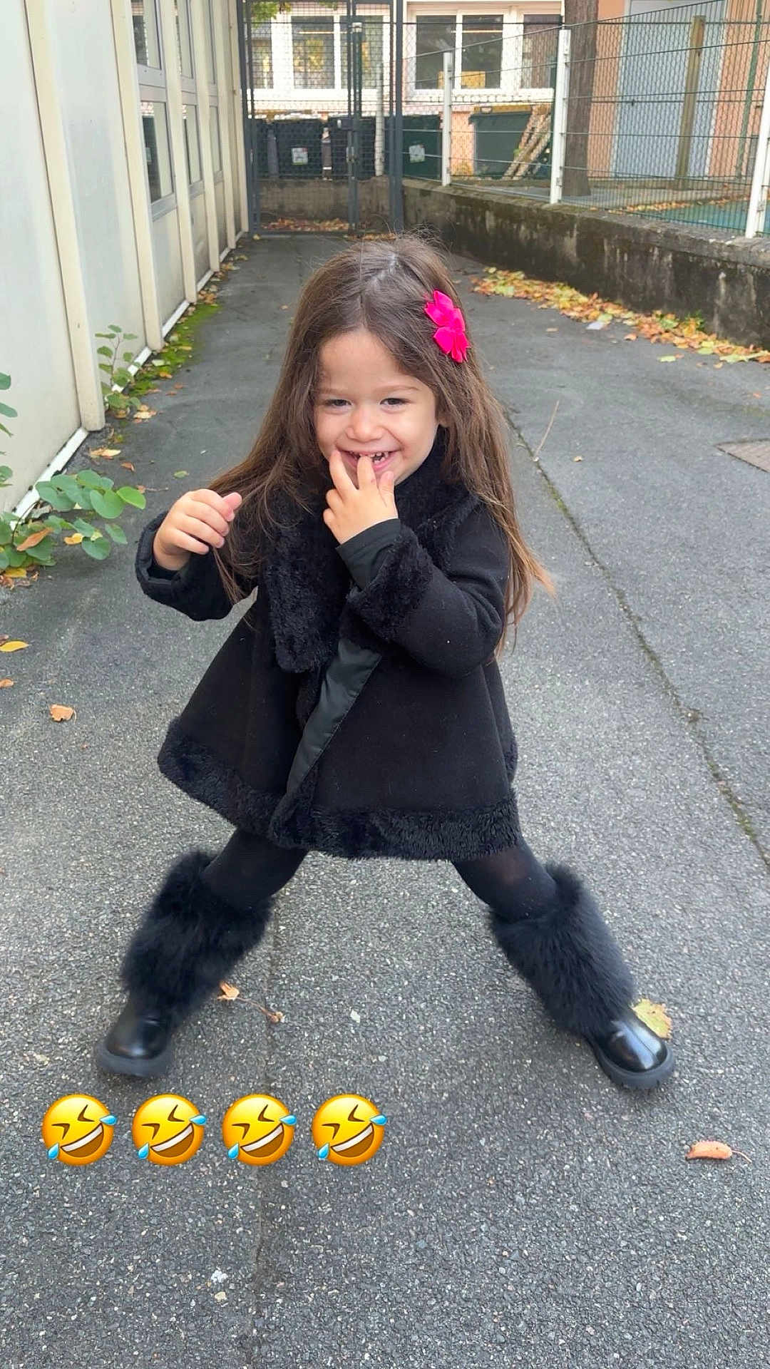 Léna a rejoint le concours — aidez-le/la à gagner de superbes lots ! child, girl, smiling, outdoor, pavement, black_clothing, fur_boots, flower_hair_clip, long_hair, playful, fence, urban, autumn_leaves, happy, cute, posing, daylight, fashion, casual, fun