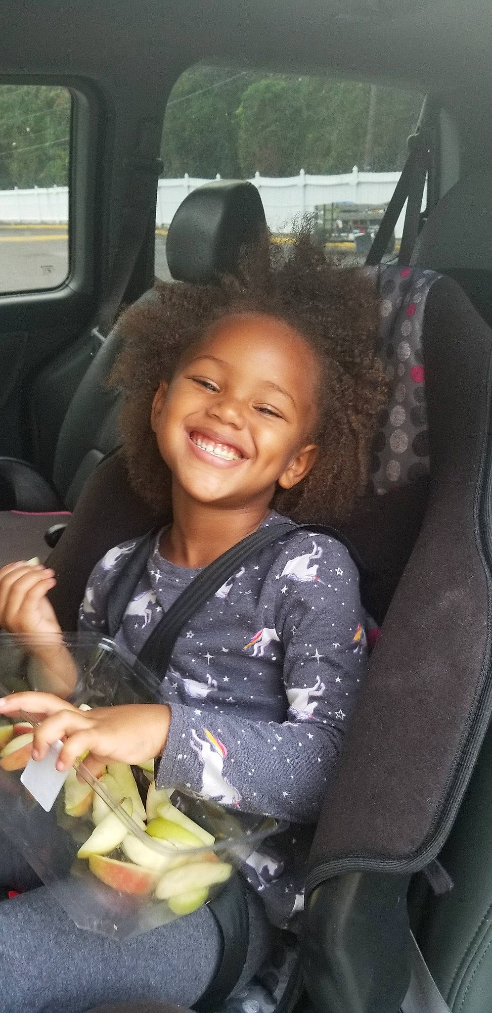 Honesty is registered to the contest to win money with this photo: auto_part, black_hair, car, car_seat, car_seat_cover, child, family_car, gesture, joy, long_hair, person, seat_belt, sitting, smile