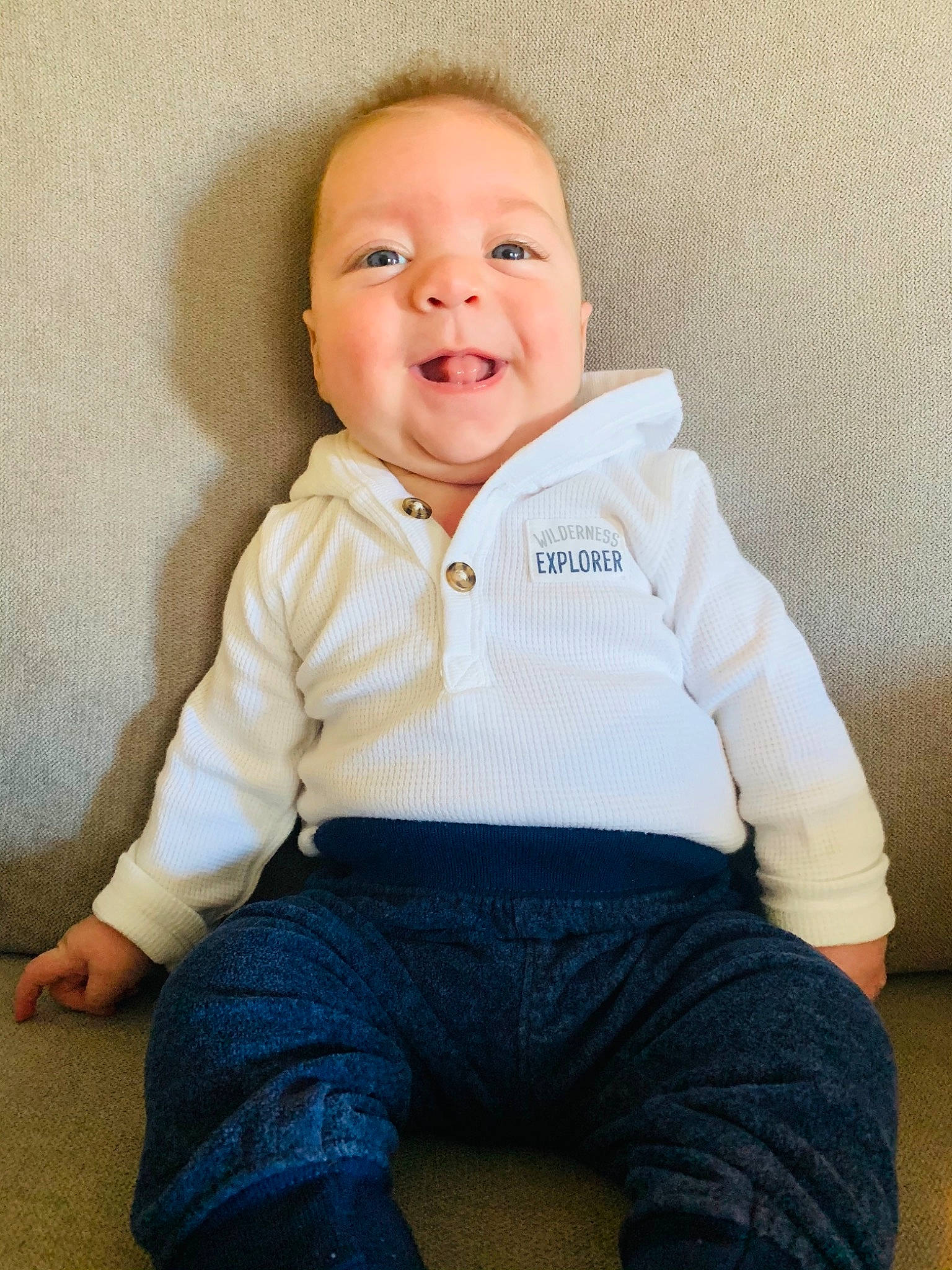 Rustin is registered to the contest to win money with this photo: baby, baby_toddler_clothing, cheek, child, child_model, comfort, denim, eye, jeans, laugh, mouth, organ, person, portrait, sitting, skin, sleeve, sock, standing, sweater