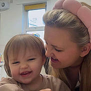 Alexis-Mai is registered to the contest to win money with this photo: child, toddler, woman, smiling, happy, face, headband, blonde_hair, indoor, kitchen, table, bottle, holding, playing, family, love, closeup, person, casual_clothing, light