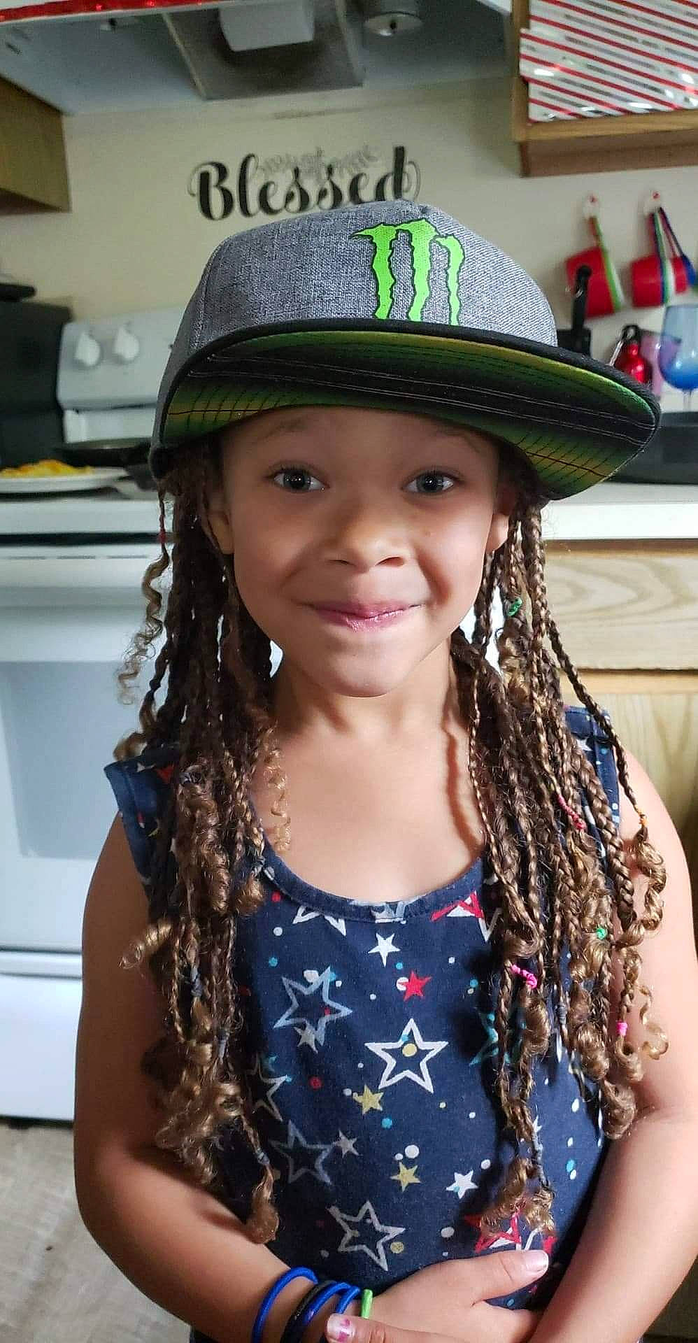 Tracie is registered to the contest to win money with this photo: black_hair, cap, clothing, cool, costume_accessory, costume_hat, dreadlocks, fashion_accessory, fedora, hair, hairstyle, hat, headgear, headwear, joy, long_hair, person, sun_hat