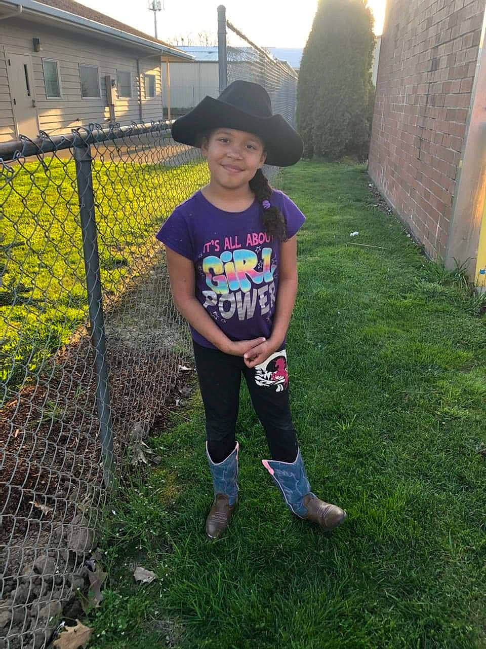 Brenda is registered to the contest to win money with this photo: backyard, child, fun, garden, grass, headwear, joy, lawn, leg, person, plant, shoe, t_shirt, tree, yard