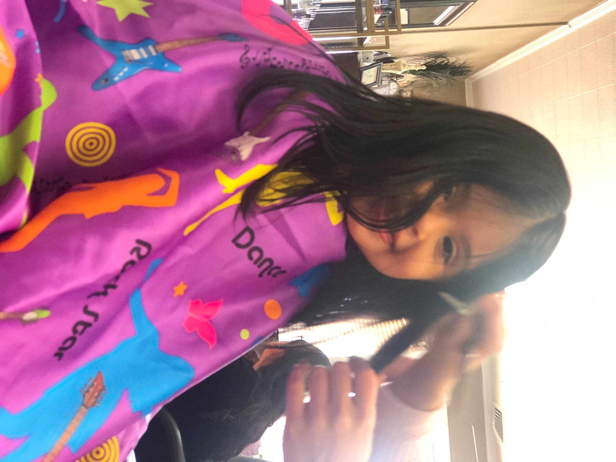 Aleena is registered to the contest to win money with this photo: black_hair, child, elbow, fashion, fun, happy, joy, linens, magenta, pattern, person, personal_protective_equipment, pink, plant, purple, room, sleeve, t_shirt, toddler, tree