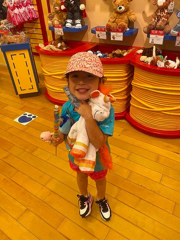 Riley joined the competition — help win amazing prizes! baby, cap, child, event, flooring, fun, happy, hat, headwear, joy, leisure, orange, person, recreation, room, shelf, shopping, smile, snapshot, toddler