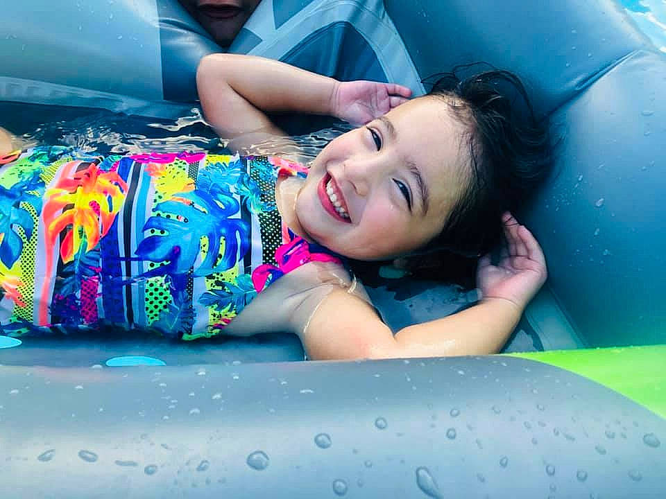 Riley is registered to the contest to win money with this photo: aqua, automotive_design, black_hair, blue, comfort, cool, eye, facial_expression, flash_photography, fun, happy, human_body, joy, leg, leisure, mouth, person, pink, recreation, smile