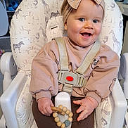 Delilah joined the competition — help win amazing prizes! animal_print, baby, bow, child, clothing, elephant, giraffe, happy, headband, high_chair, indoor, lion, person, seatbelt, smile, socks, toddler, toy, wooden_beads, zebra