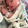 Legend is registered to the contest to win money with this photo: newborn, baby, infant, blanket, tattoo, hospital, wristband, person, skin, face, hand, clothing, bed, furniture, closeup, indoors, resting, wrapping, comfort, tender