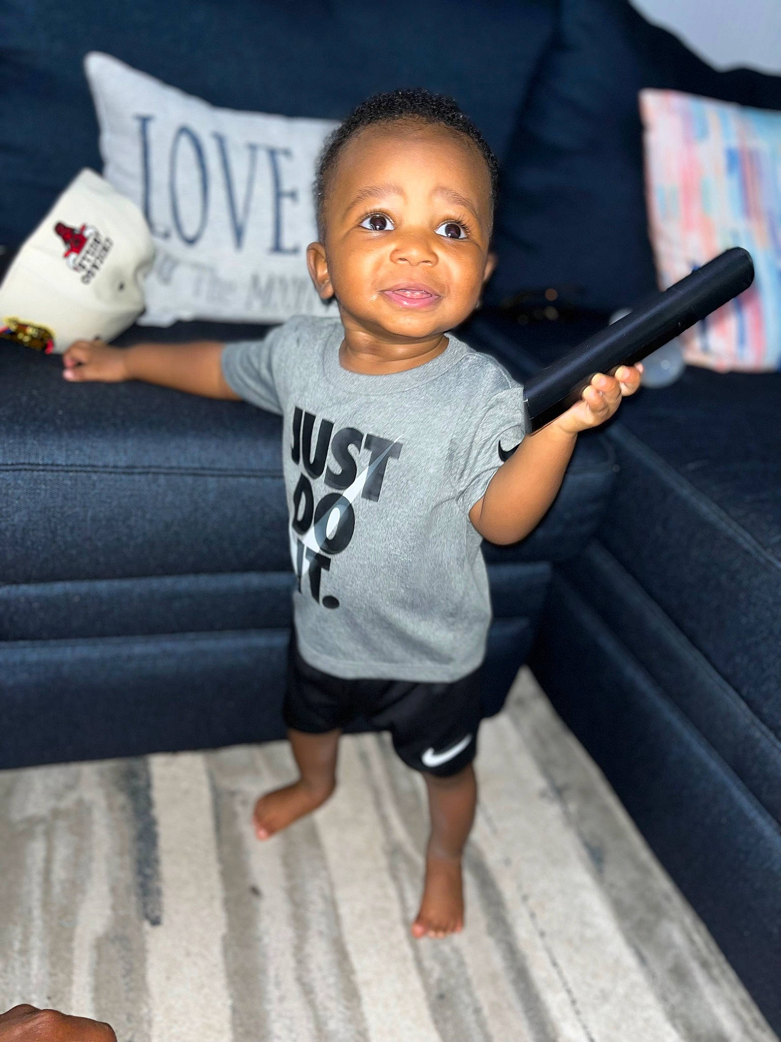 Adaire is registered to the contest to win money with this photo: baby, baby_toddler_clothing, elbow, finger, flash_photography, flooring, fun, gadget, gesture, happy, joint, leisure, microphone, neck, person, sitting, sleeve, t_shirt, textile, thumb