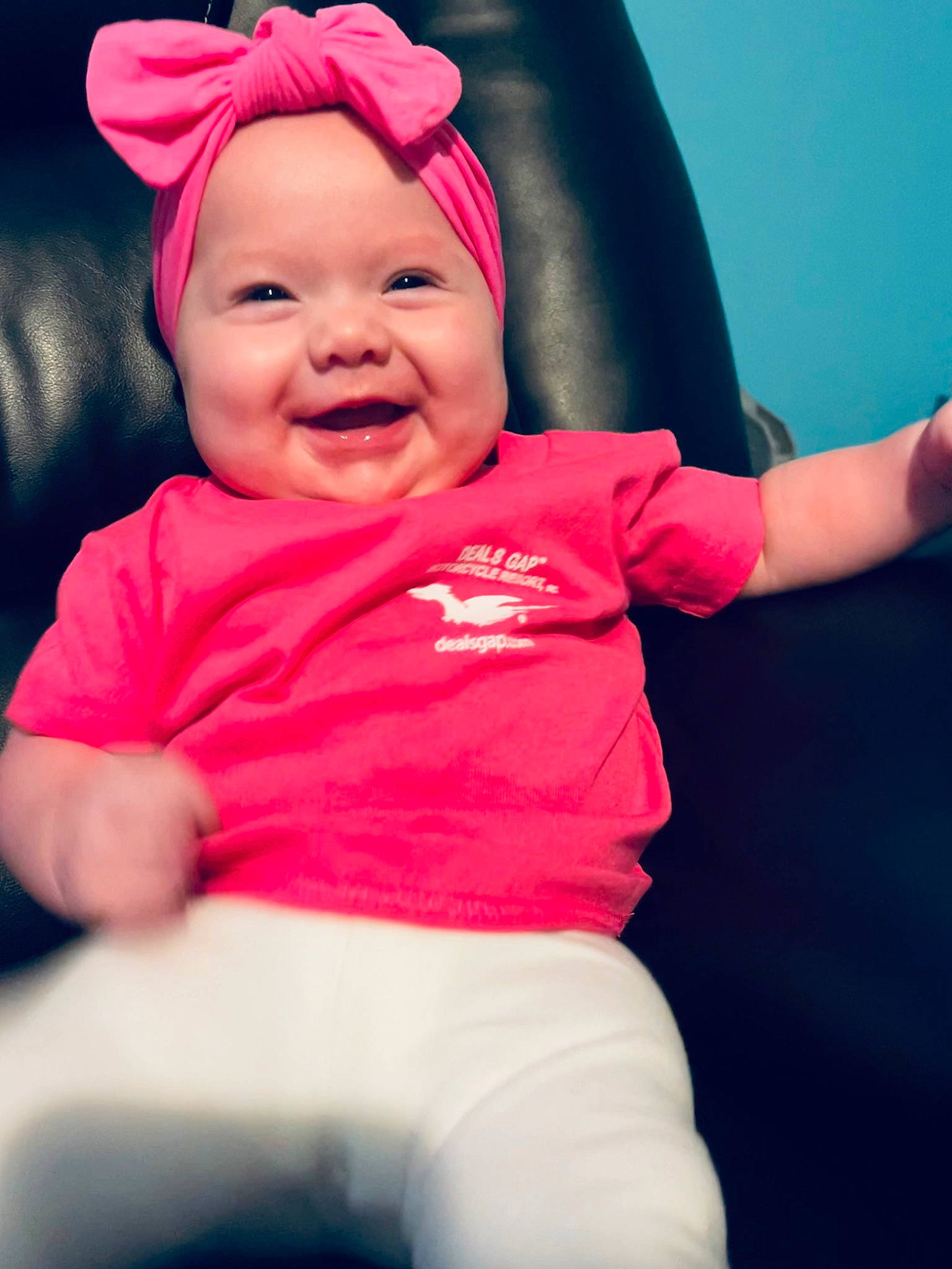 Ayla is registered to the contest to win money with this photo: baby, baby_laughing, baby_toddler_clothing, cap, chin, eye, face, gesture, happy, head, headgear, headwear, human_body, joy, lip, mouth, outerwear, person, pink, sleeve