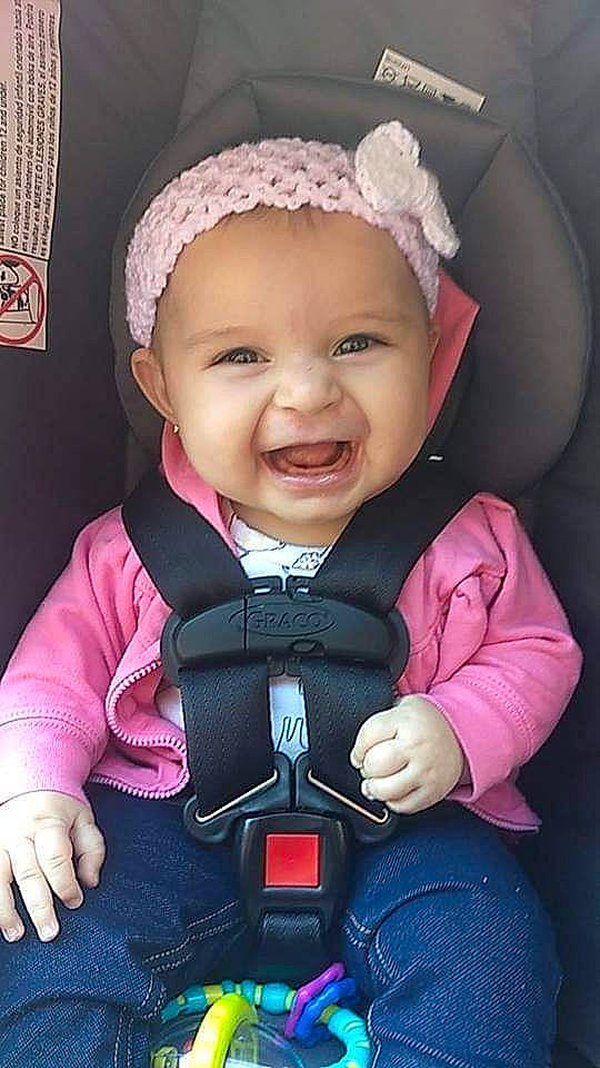 Beatrice is registered to the contest to win money with this photo: baby, baby_carriage, baby_in_car_seat, baby_products, baby_toddler_clothing, car_seat, cheek, child, hair_accessory, happy, headgear, joy, person, pink, product, skin, smile, toddler