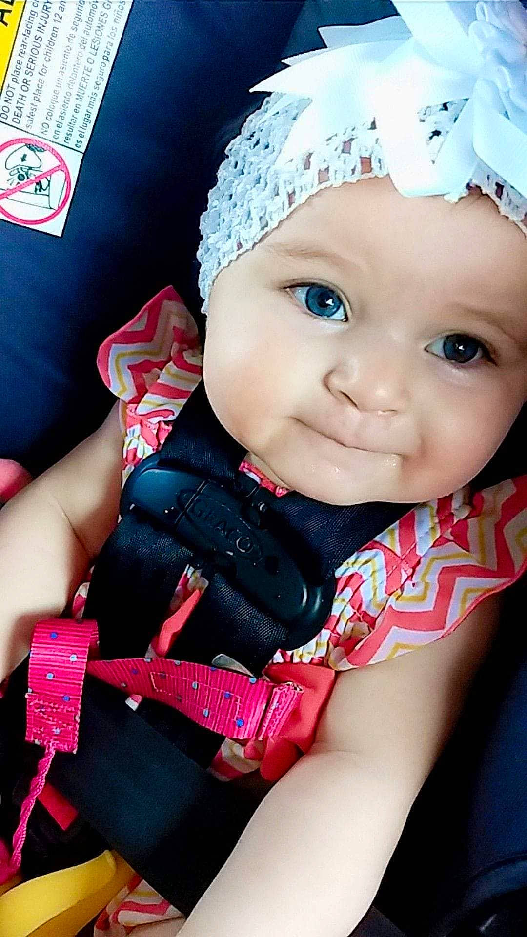 Beatrice is registered to the contest to win money with this photo: baby, baby_products, baby_toddler_clothing, car_seat, cheek, child, child_model, doll, fashion_accessory, hair_accessory, headband, headgear, person, pink, product, skin, smile, toddler