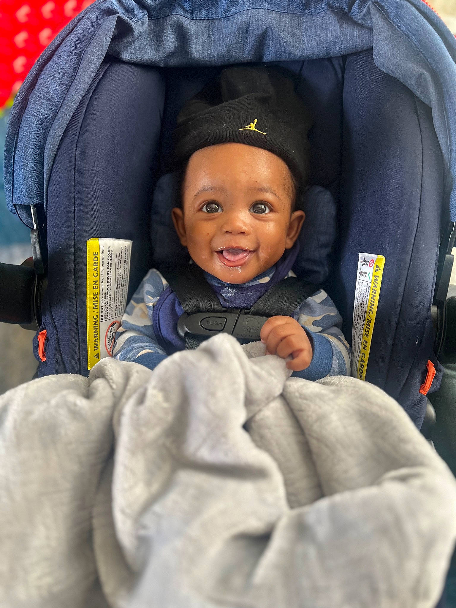 Chance is registered to the contest to win money with this photo: auto_part, baby, baby_carriage, baby_in_car_seat, baby_products, car_seat, car_seat_cover, child, comfort, electric_blue, fun, happy, head_restraint, outerwear, passenger, person, purple, sitting, smile, thumb