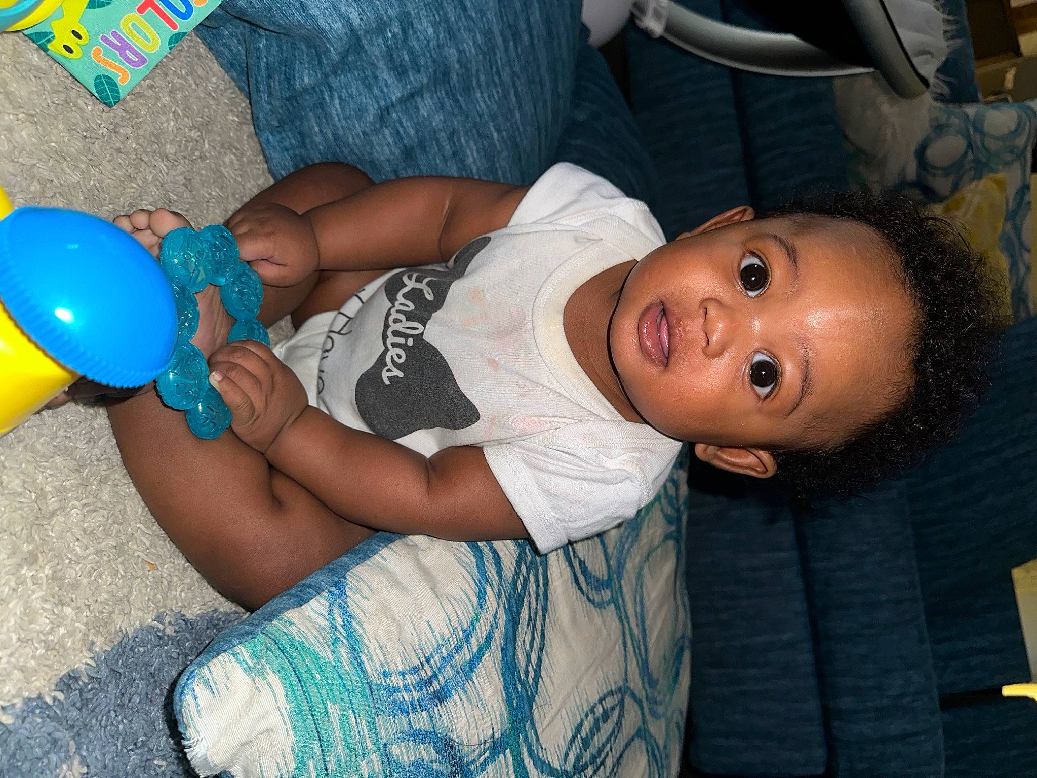 Chance is registered to the contest to win money with this photo: baby, baby_playing_with_toys, baby_products, baby_toddler_clothing, child, electric_blue, fun, happy, nail, party, party_supply, person, sitting, smile, t_shirt, thigh, toddler, toy