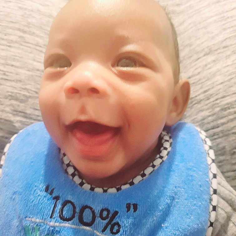 Hadar joined the competition — help win amazing prizes! baby, bib, cheerful, child, closeup, clothing, cute, expression, face, happy, head, indoors, infant, joy, person, portrait, sitting, skin, smiling, young