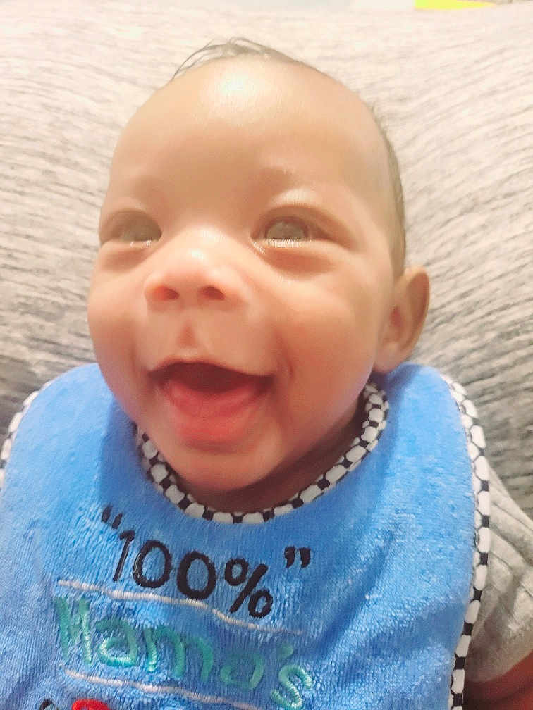 Hadar joined the competition — help win amazing prizes! baby, bib, cheerful, child, closeup, clothing, cute, expression, face, happy, head, indoors, infant, joy, person, portrait, sitting, skin, smiling, young