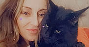 Kiwi joined the competition — help win amazing prizes! woman, cat, black_cat, pet, selfie, indoor, bed, headboard, long_hair, portrait, cute, heart_sticker, cozy, feline, animal, face, closeup, home, relaxation, friendship
