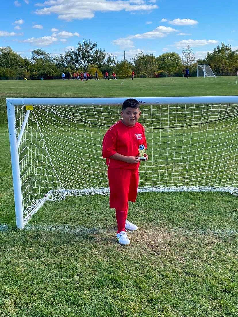 Bryan joined the competition — help win amazing prizes! ball_game, cloud, competition_event, goal, grass, grassland, headwear, joy, leisure, mesh, net, people_in_nature, person, player, playing_sports, recreation, shrub, sky, soccer, sports