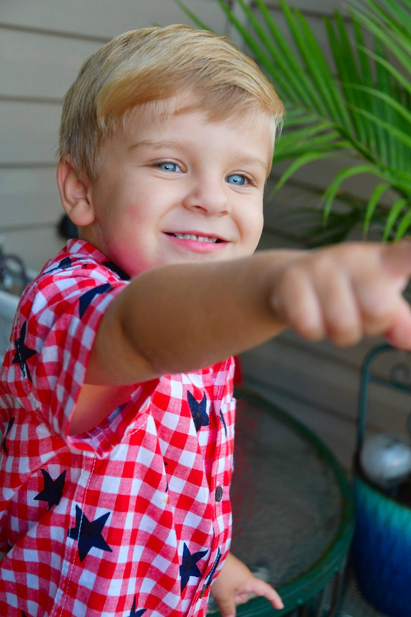 Billy is registered to the contest to win money with this photo: baby, cheek, child, design, eye, face, finger, fun, head, joy, nose, pattern, person, plaid, skin, smile, toddler, vacation