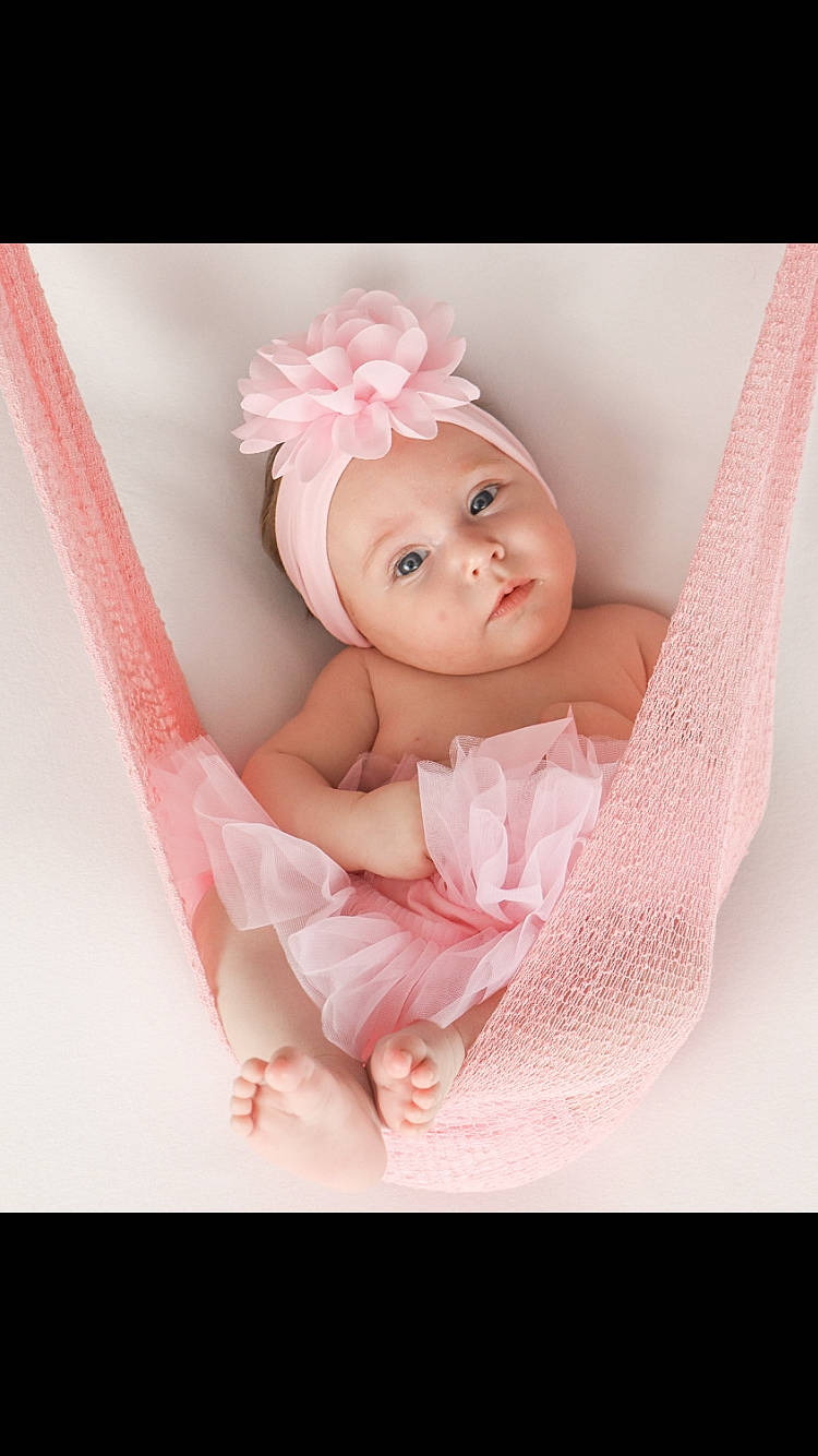 Ciana participe au concours pour gagner de l'argent avec cette photo : arm, baby, baby_products, baby_toddler_clothing, baby_toys, bed, comfort, doll, fashion_accessory, hair_accessory, hand, headpiece, headwear, linens, magenta, peach, person, petal, pink, smile
