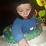 baby, birthdaycake, bodypart, bonnet, cake, cap, clothing, cream, dessert, face, finger, food, hand, hat, head, icing, knitwear, person, photography, portrait