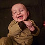 baby, babylaughing, bodypart, clothing, coat, couch, face, finger, furniture, hand, happy, head, jacket, laughing, pants, person, photography, portrait, sitting, smile