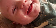 Duwane is registered to the contest to win money with this photo: applique, baby, babylaughing, bodypart, clothing, face, finger, hand, happy, hardwood, head, knitwear, mouth, newborn, person, photography, portrait, smile, sweater, wood