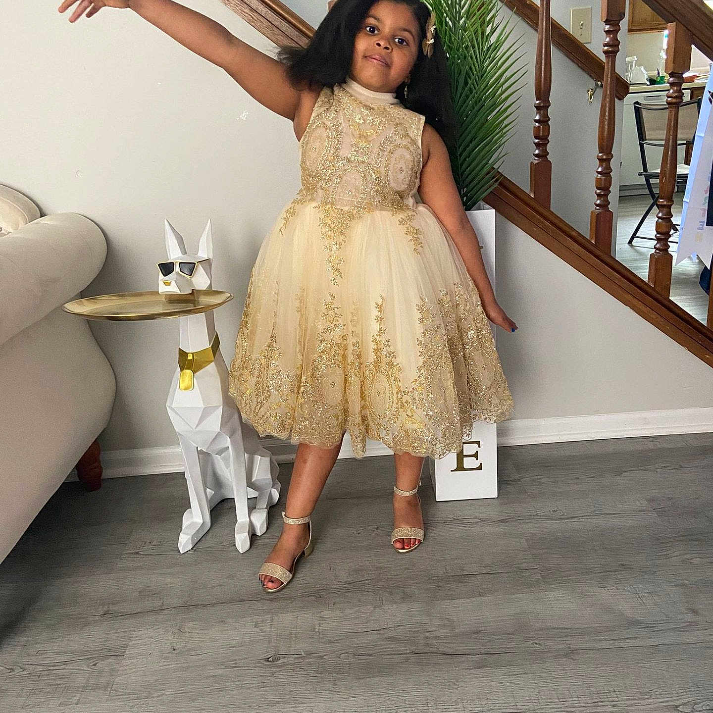 Emma Vibert joined the competition — help win amazing prizes! child, decoration, dog_statue, dress, floor, footwear, furniture, girl, gold, happy, home, indoor, plant, pose, side_table, smile, sparkle, stairs, sunglasses, wood