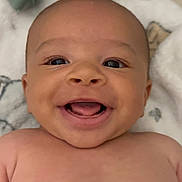 Neurey is registered to the contest to win money with this photo: baby, smiling, face, skin, blanket, happy, infant, child, portrait, cute, cheerful, lying_down, closeup, soft_texture, casual, clothing, expression, human, indoors, young