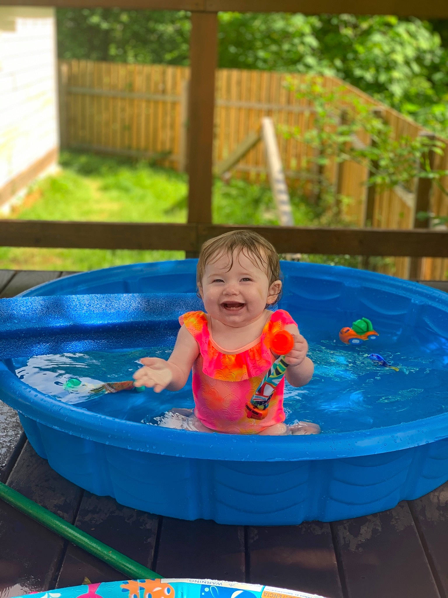 Aaiyla is registered to the contest to win money with this photo: aqua, baby, baby_products, baby_toddler_clothing, bathing, child, electric_blue, fence, fun, grass, happy, joy, leisure, person, play, product, recreation, smile, summer, toddler
