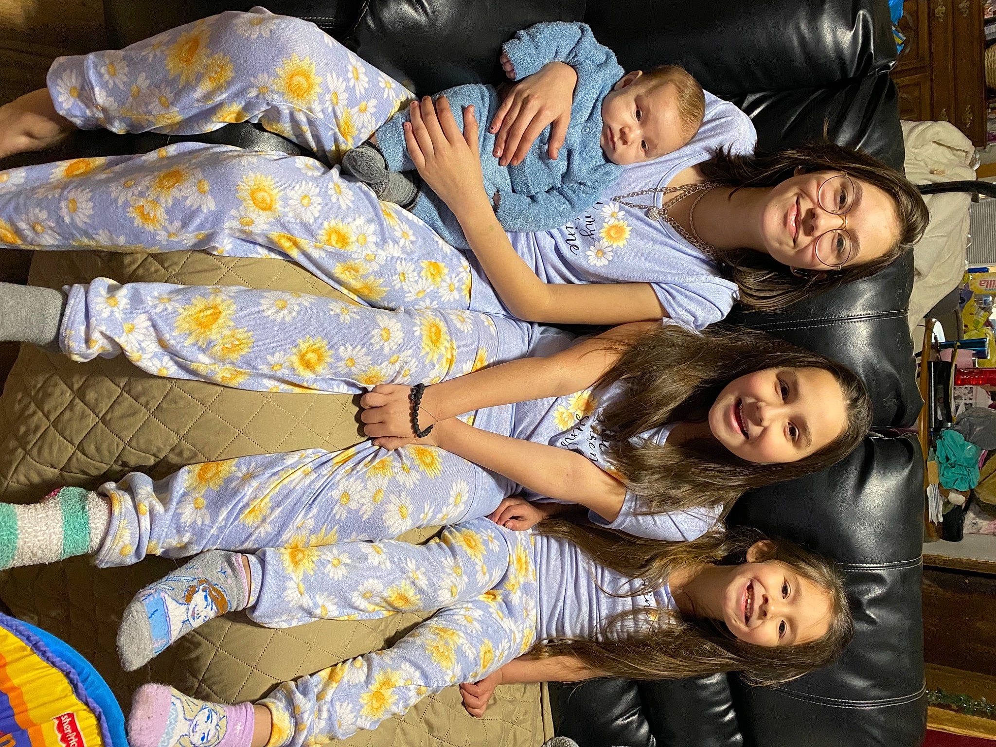 Cheyanne is registered to the contest to win money with this photo: black, child, comfort, couch, event, fun, happy, human_leg, joy, lap, leg, leisure, pattern, person, room, sitting, smile, t_shirt, textile, thigh