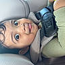 Kayden is registered to the contest to win money with this photo: baby, child, car_seat, toy, green_sweater, curious, face, wide_eyes, playful, seatbelt, child_safety, infant, cute, indoors, car_interior, portrait, holding_toy, happy, young_child, closeup