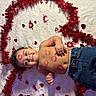 adorable, baby, blanket, child, cute, decorations, face, festive, happy, heart_shaped_tinsel, holiday, infant, jeans, lipstick_marks, love, lying_down, red_hearts, shirtless, skin, smiling