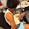 Kayden is registered to the contest to win money with this photo: arm, baby, baby_bassinet, blanket, chair, clothing, cradle, curtain, face, floor, furniture, hair, indoor, leg, man, necklace, newborn, person, socks, window