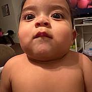 Kayden is registered to the contest to win money with this photo: baby, child, face, indoor, curious, wide_eyes, expression, skin, head, shoulders, television, furniture, room, person, living_room, casual, portrait, young, home, close_up