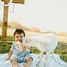 baby, child, goat, animal, grass, outdoor, blanket, cross, wood, sunlight, field, nature, cute, curious, infant, overalls, white, peaceful, portrait, daytime