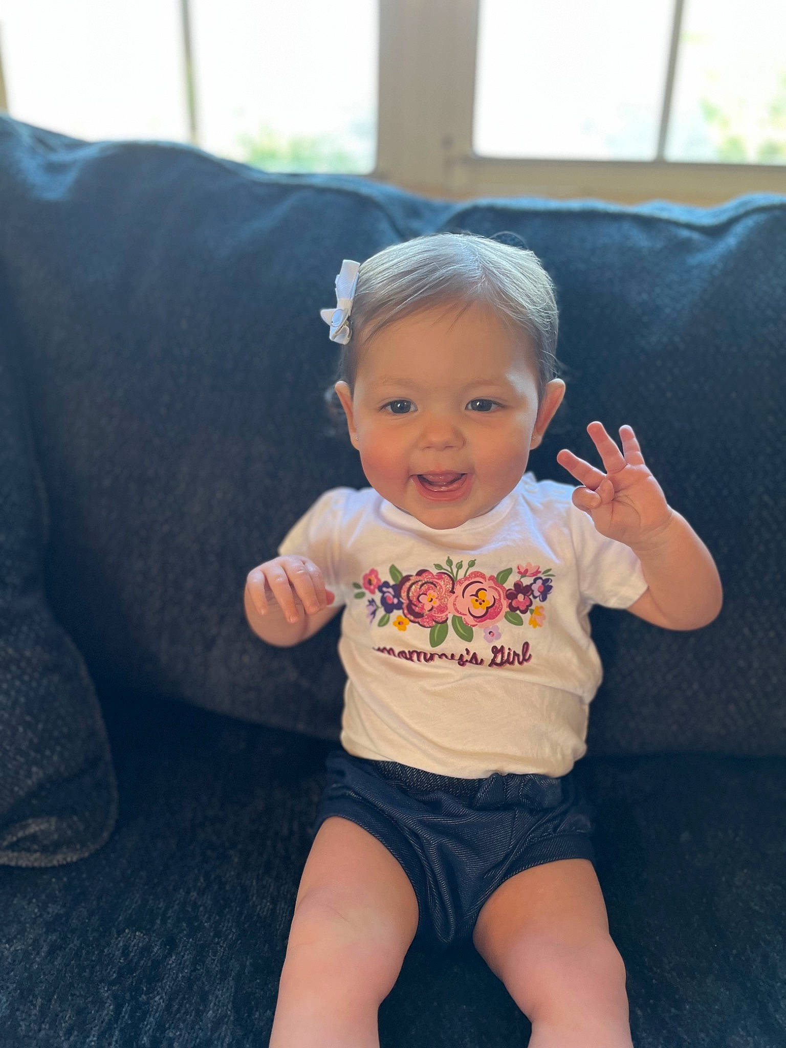 Eden is registered to the contest to win money with this photo: baby, baby_toddler_clothing, child, cool, eye, face, facial_expression, finger, grass, hairstyle, hand, happy, head, person, skin, sleeve, smile, t_shirt, thigh, thumb