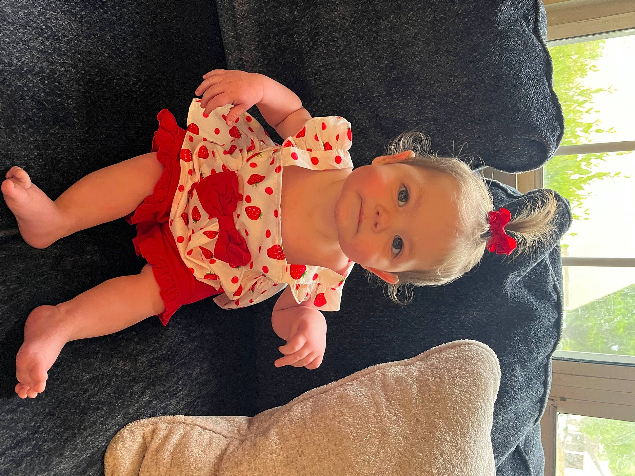 Eden joined the competition — help win amazing prizes! baby, baby_toddler_clothing, child, comfort, dress, happy, hat, human_body, human_leg, lap, leg, person, plant, sitting, sleeve, sock, thigh, toddler, tree, vertebrate