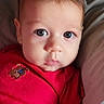 baby, blue_eyes, child, closeup, couch, cute, face, indoors, infant, looking, newborn, onesie, person, pillow, portrait, red_clothing, resting, skin, soft_lighting, young_child