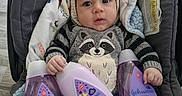 Luciano is registered to the contest to win money with this photo: baby, baby_bath_products, baby_carrier, blanket, child, cozy, cute, flooring, indoors, infant, johnsons, knitted_clothing, newborn, person, portrait, purple_bottles, raccoon_outfit, soft_toys, warm_clothing, wide_eyes