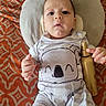 Luciano joined the competition — help win amazing prizes! baby, blanket, child, clothing, curious, face, golden_bottle, hand, indoors, infant, koala, lying_down, onesie, orange, pattern, pillow, portrait, spray_bottle, striped, white