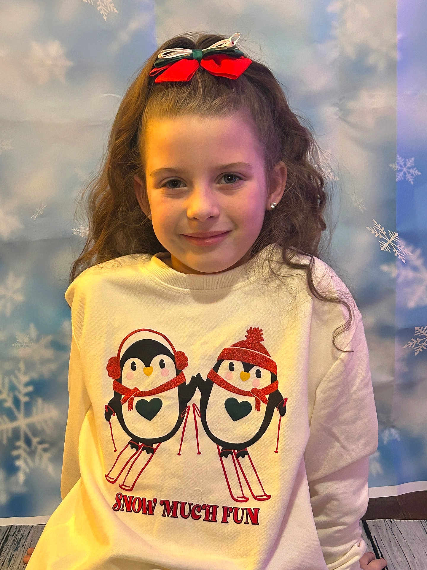 Scarlet is registered to the contest to win money with this photo: child, girl, smile, bow, hair, sweatshirt, penguin, winter, snowflake, background, portrait, clothing, cute, holiday, fun, indoor, fashion, headwear, kid, happy