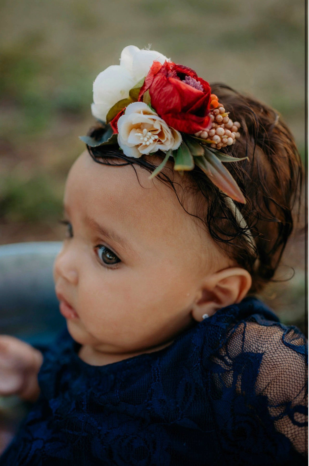Alanis is registered to the contest to win money with this photo: baby, baby_toddler_clothing, chin, eye, eyebrow, eyelash, fashion_accessory, flower, grass, hair_accessory, happy, headband, headgear, headpiece, iris, jewellery, person, petal, plant, rose