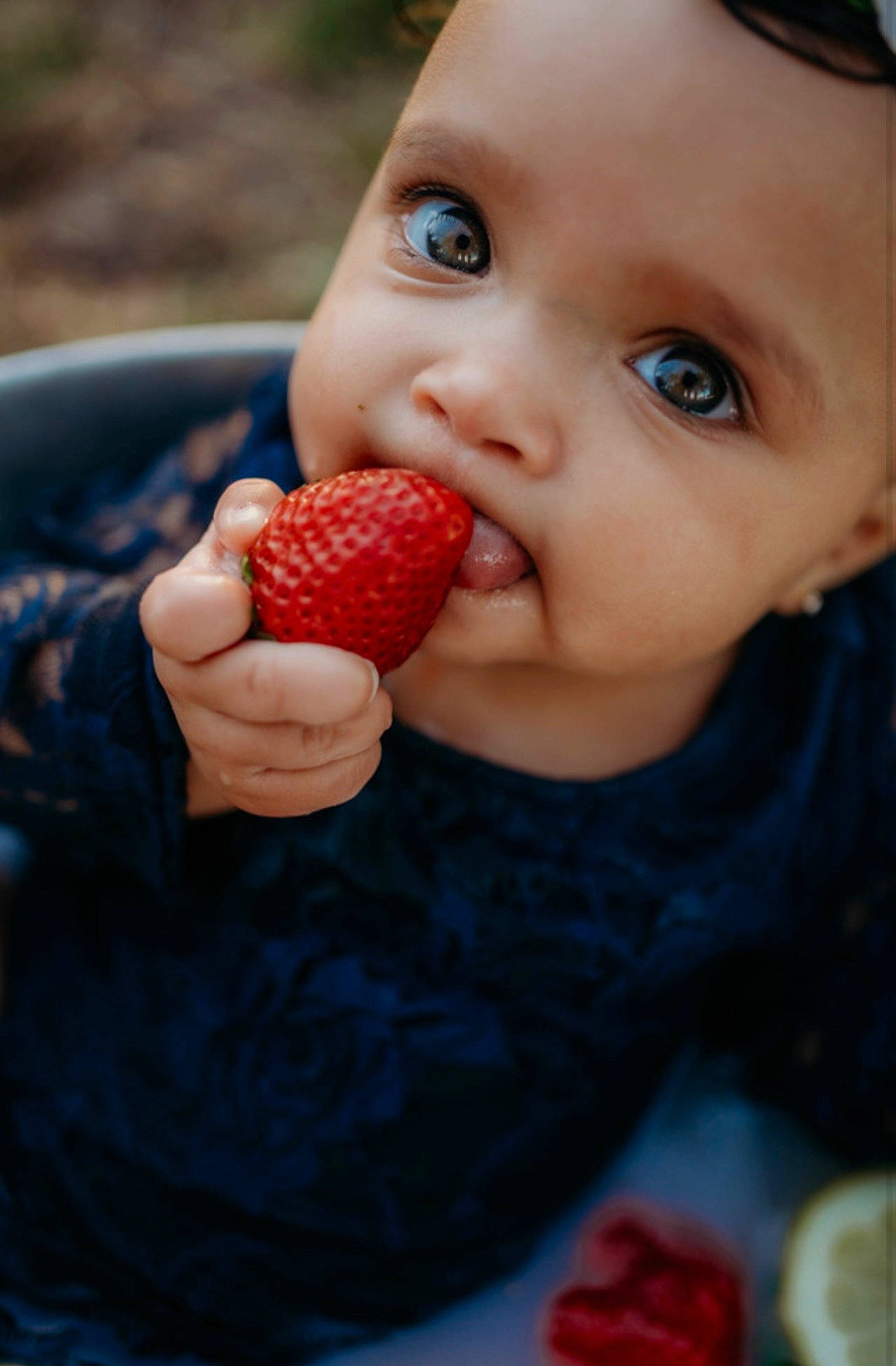 Alanis is registered to the contest to win money with this photo: baby, biting, child, food, fruit, gesture, hand, lip, natural_foods, nose, person, plant, recipe, red, seedless_fruit, skin, strawberries, strawberry, superfood, toddler