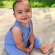 Ezequiel is registered to the contest to win money with this photo: baby, barefoot, blanket, blue_outfit, casual_clothing, child, cute, face, greenery, happy, infant, natural_light, one_person, outdoor, portrait, sitting, skin, smile, toddler, young_child
