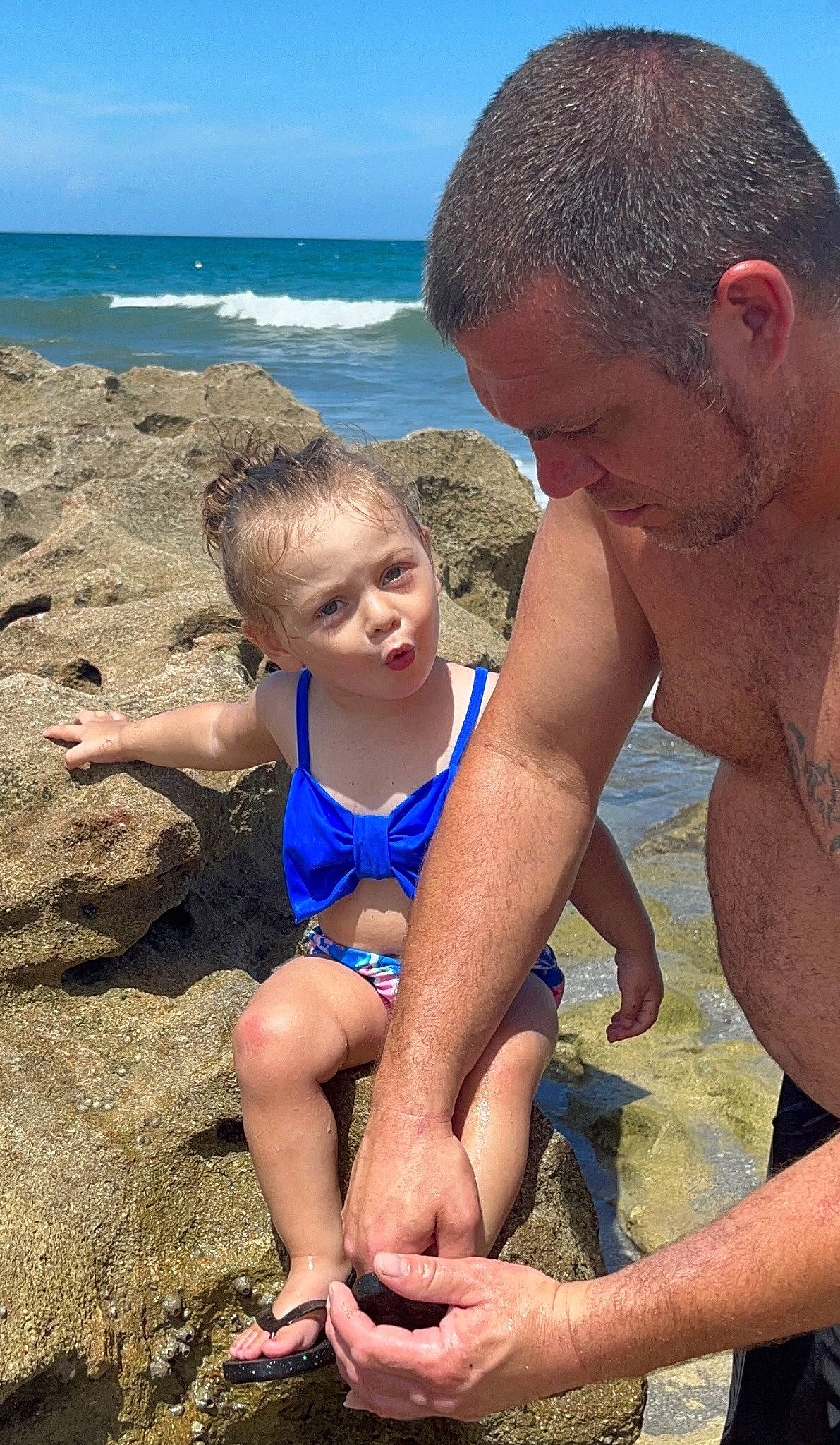 Mckenzie is registered to the contest to win money with this photo: arm, beach, blue, fun, hand, happy, head, human_body, leg, leisure, muscle, natural_environment, organ, people_on_beach, person, photograph, shorts, sky, summer, thigh